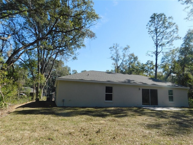 14268 SE 27th Ct, Summerfield, FL 34491 - back of property with a yard, stucco siding, and a patio area