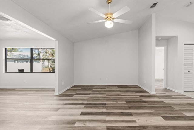 empty room featuring wood-type flooring, lofted ceiling, and ceiling fan