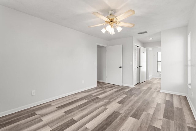 spare room featuring light hardwood / wood-style flooring and ceiling fan