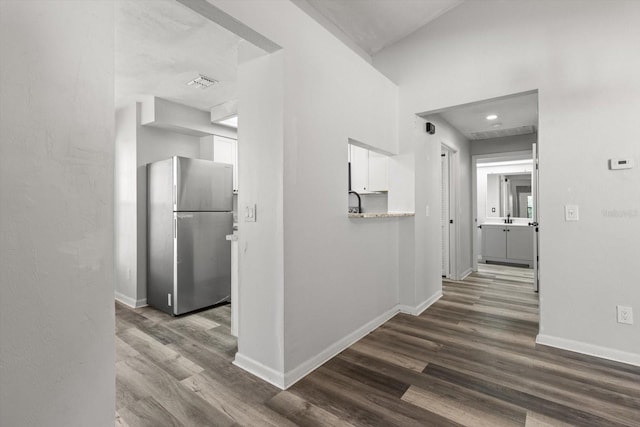 hallway with dark hardwood / wood-style floors