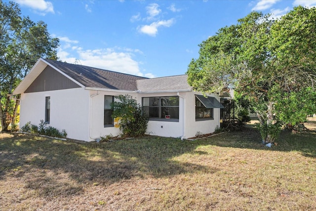 view of side of property featuring a yard