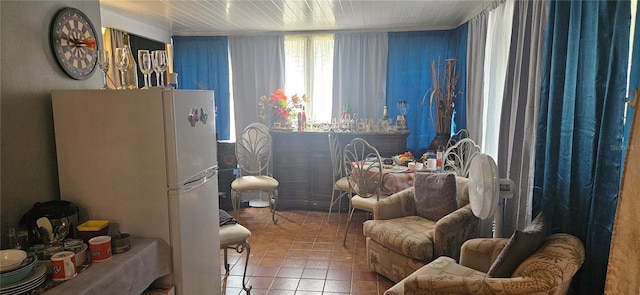 interior space featuring white refrigerator and tile patterned flooring