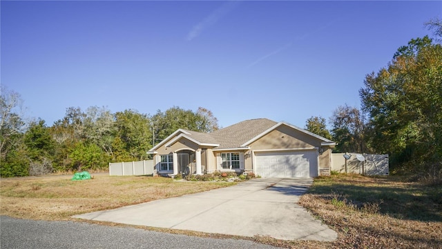 single story home with a garage and a front lawn