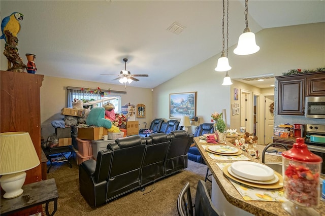 living room with dark colored carpet, vaulted ceiling, and ceiling fan