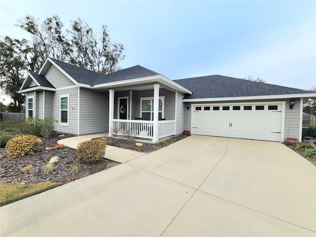 ranch-style house with a garage and covered porch