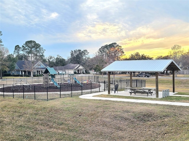 view of property's community featuring a lawn and a playground