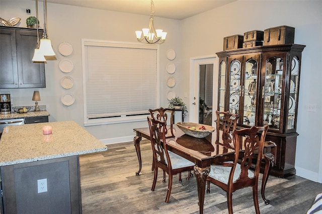 dining space featuring an inviting chandelier and dark hardwood / wood-style flooring