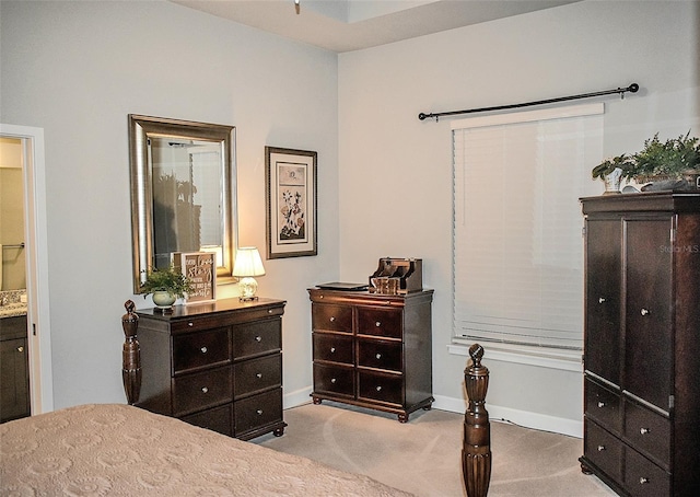 carpeted bedroom featuring connected bathroom