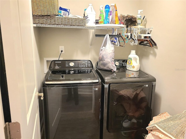 clothes washing area featuring washer and dryer