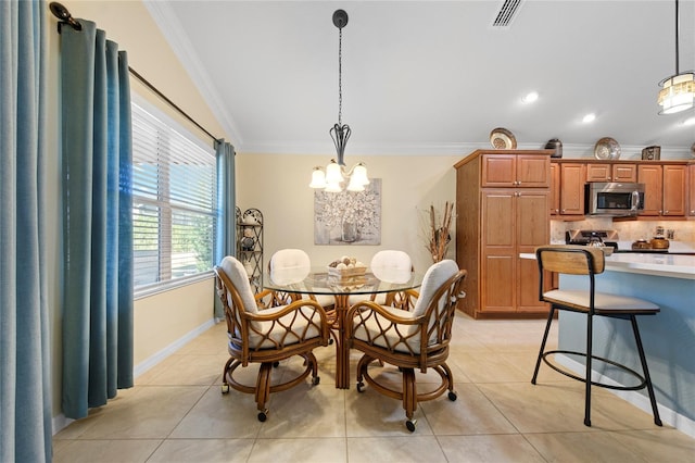 dining room with crown molding, light tile patterned flooring, and an inviting chandelier