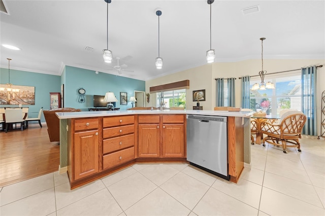 kitchen with pendant lighting, light tile patterned floors, crown molding, and stainless steel dishwasher