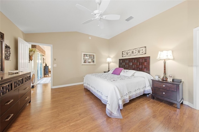 bedroom with ceiling fan, lofted ceiling, and light hardwood / wood-style flooring