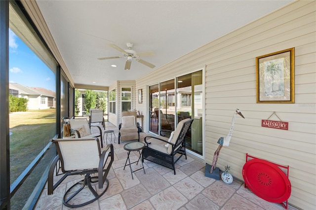 sunroom with ceiling fan