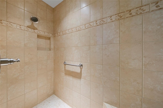 bathroom with tiled shower