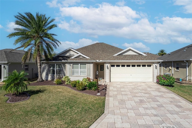 ranch-style house featuring a garage and a front lawn