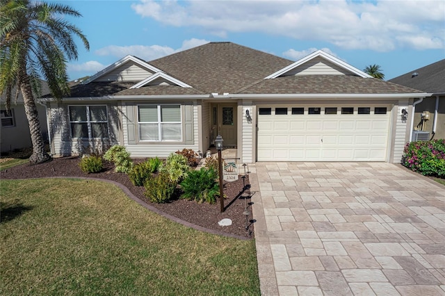 single story home with a garage and a front yard