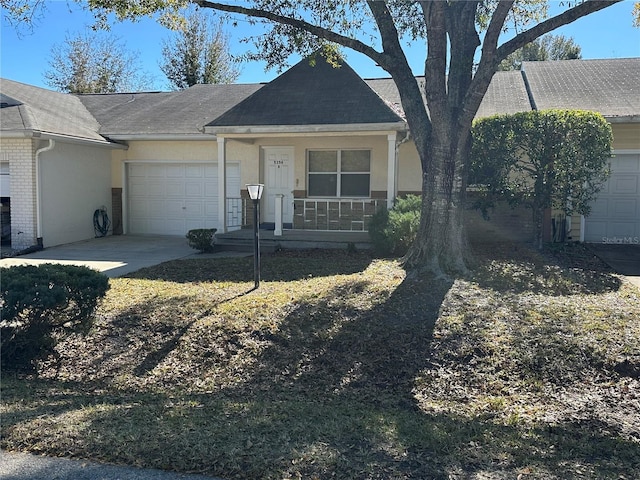 ranch-style home with a garage and a porch