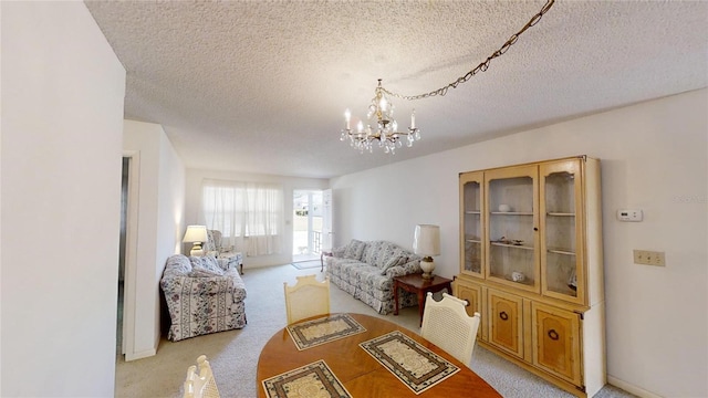 carpeted living room with a chandelier and a textured ceiling