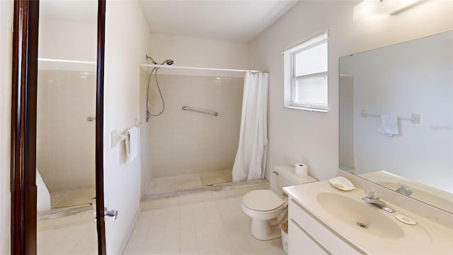 bathroom featuring toilet, vanity, and a shower with curtain