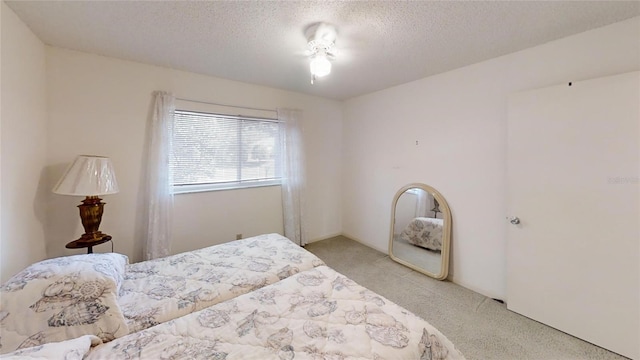 carpeted bedroom featuring a textured ceiling