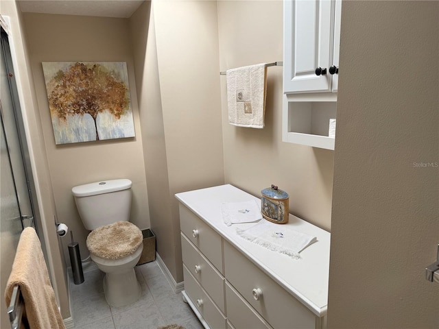 bathroom featuring tile patterned flooring, vanity, and toilet