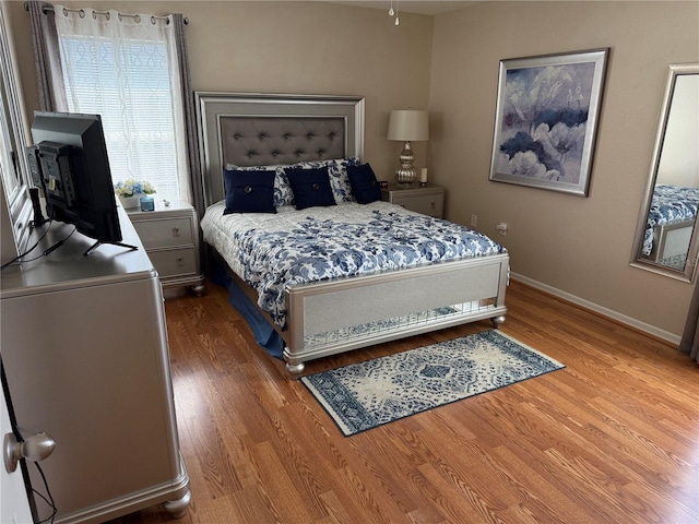 bedroom with wood-type flooring