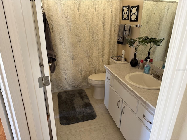 bathroom featuring vanity, tile patterned floors, and toilet