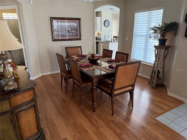 dining space with sink and hardwood / wood-style floors