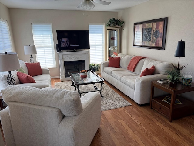 living room with wood-type flooring and ceiling fan