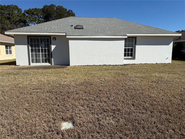 back of house featuring a yard