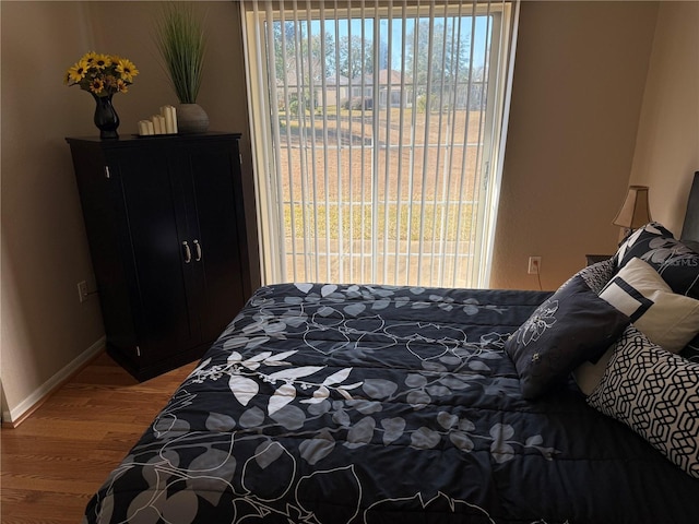 bedroom with wood-type flooring