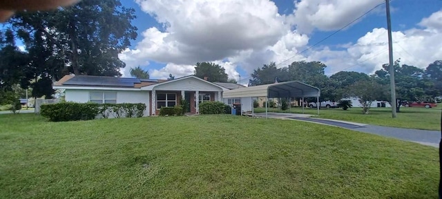 single story home featuring a front yard and a carport