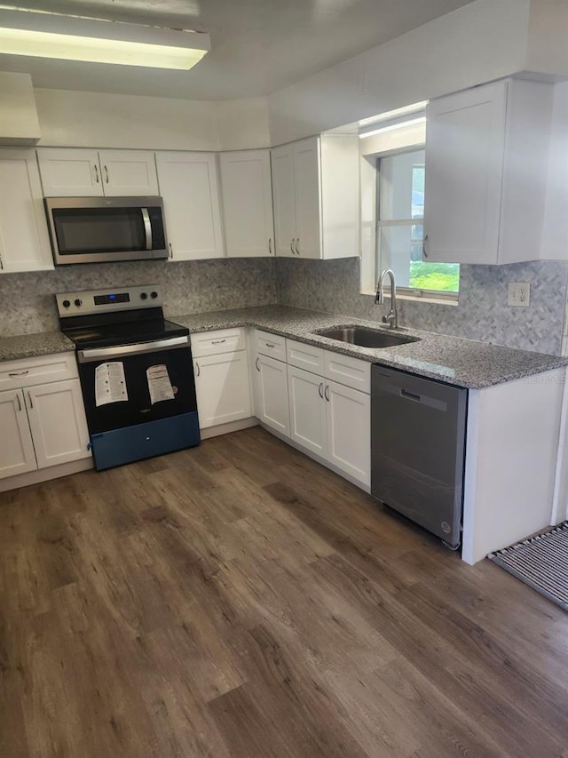 kitchen featuring range with electric stovetop, sink, white cabinets, dishwashing machine, and dark wood-type flooring