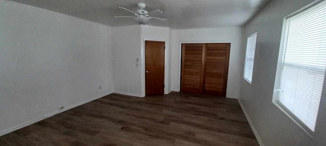 unfurnished bedroom featuring dark wood-type flooring and ceiling fan