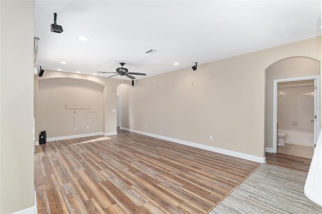 unfurnished living room with ceiling fan and light wood-type flooring