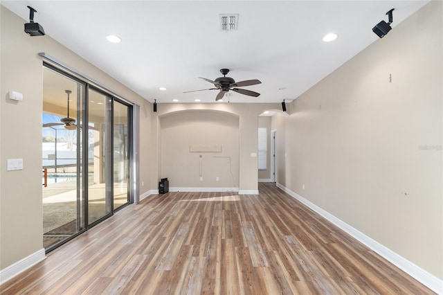 unfurnished living room with hardwood / wood-style flooring and ceiling fan