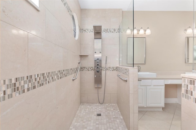 bathroom featuring tile patterned floors, vanity, and a tile shower