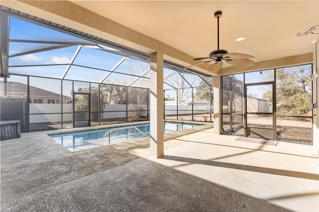 view of swimming pool with ceiling fan, a lanai, and a patio area