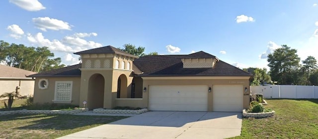 view of front of house featuring a garage and a front lawn