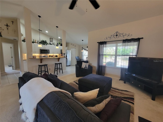 tiled living room with ceiling fan and high vaulted ceiling