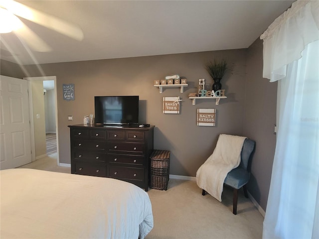 bedroom with light colored carpet and ceiling fan