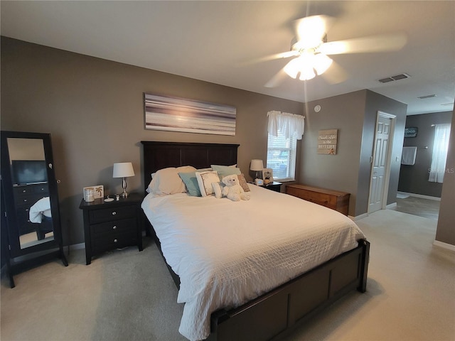 bedroom featuring light colored carpet and ceiling fan