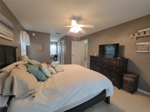 bedroom with light carpet and ceiling fan