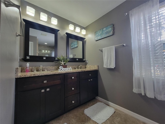 bathroom featuring tile patterned flooring and vanity