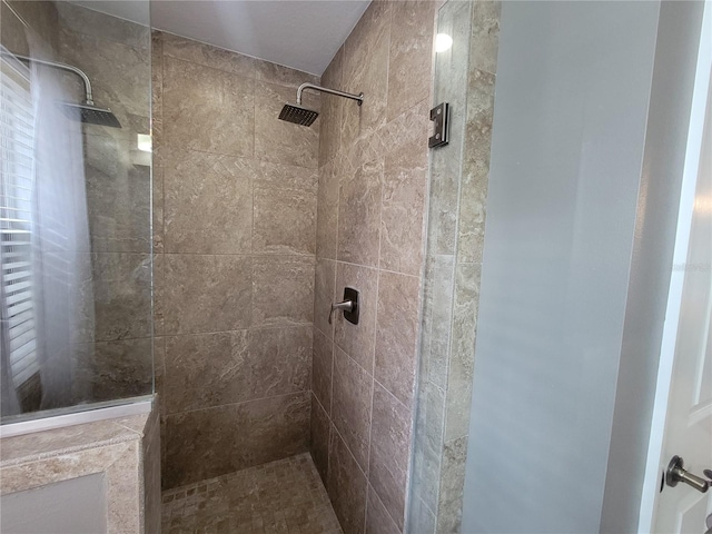 bathroom with tiled shower