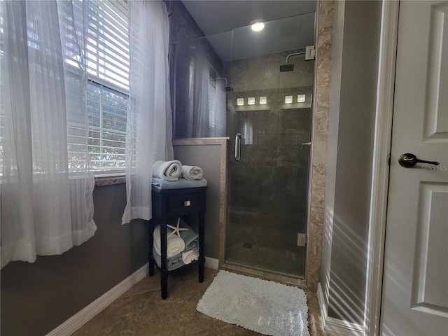 bathroom featuring a shower with shower door and tile patterned flooring