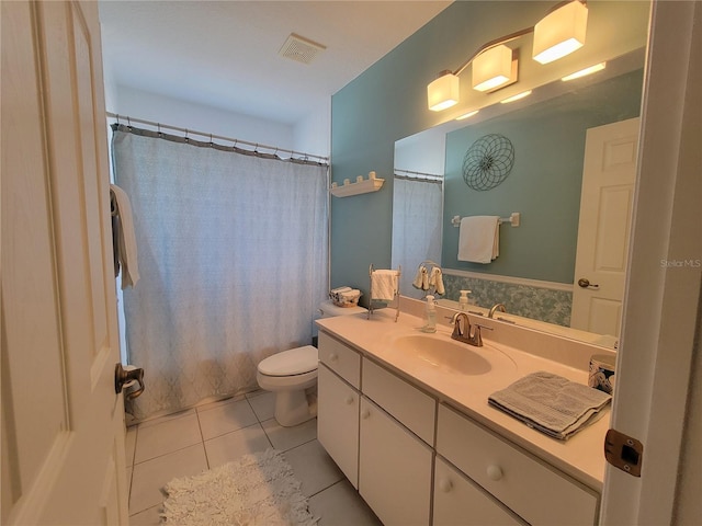 bathroom featuring vanity, tile patterned floors, and toilet