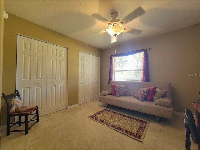 carpeted living room featuring ceiling fan