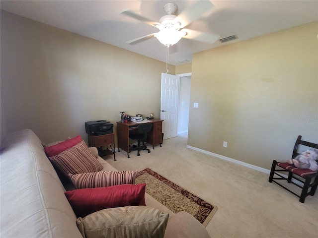 carpeted office space with ceiling fan