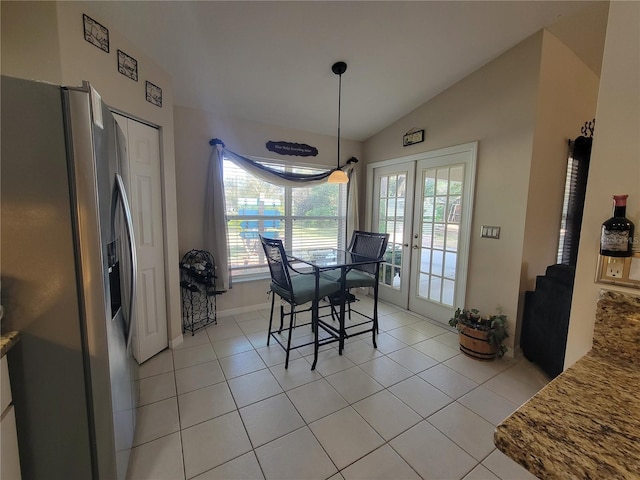 dining room featuring vaulted ceiling, french doors, and light tile patterned flooring